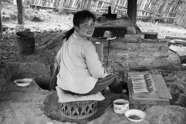 A Laotian artisan crafting from reclaimed metal.